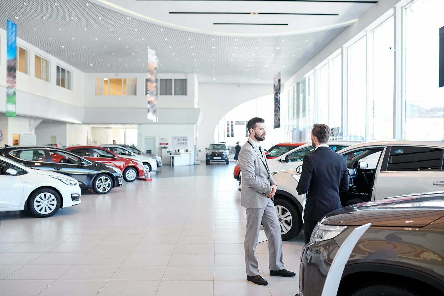 People in auto showroom Park City Dealership Cleaning